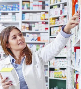 Photo of a professional pharmacist checking stock in an aisle of
